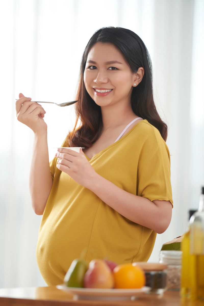 pregnant woman eating yogurt