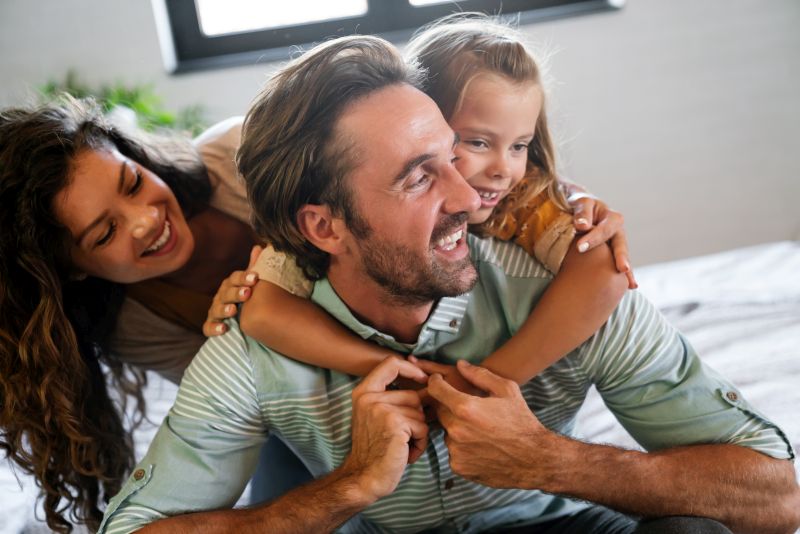 Young family being playful at home.