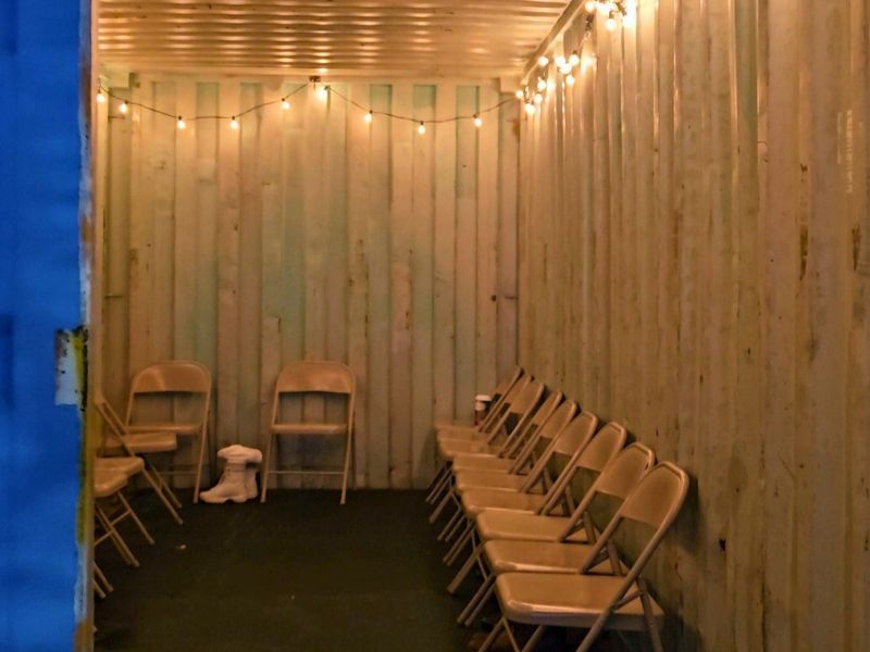 take a seat, and change into your skates in the lit and decorated shipping container at rosa parks circle ice rink downtown grand rapids