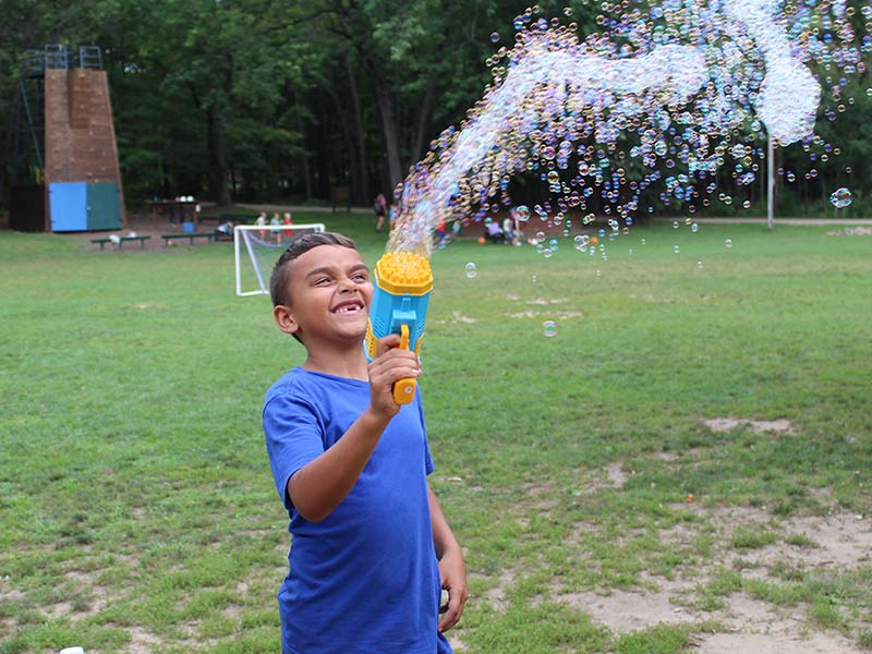 YMCA Camp Manitou-Linn - Summer Camp 2025 - Boy with bubble Blower