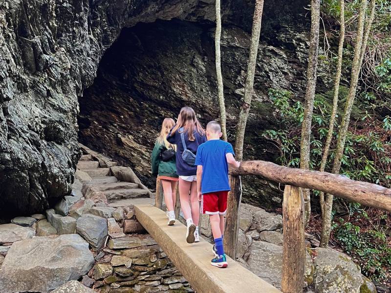 Smoky Mountains Hiking. Kids cross a log bridge on the trail to Alum Cave Bluffs in the springtime.