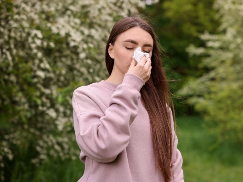 FCP Allergy girl with tissue by flowering tree