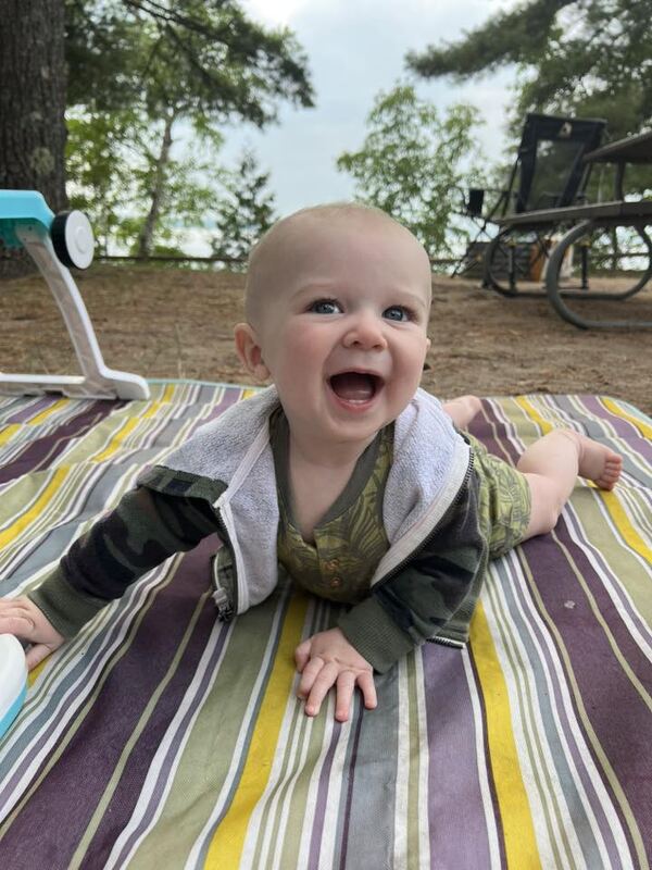 adorable baby on blanket, camping