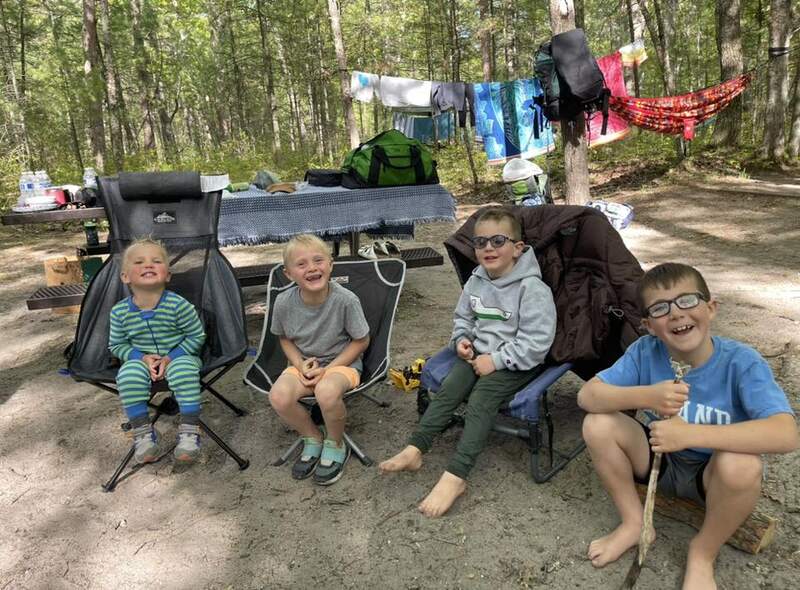 kids in kid chairs camping, laundry line