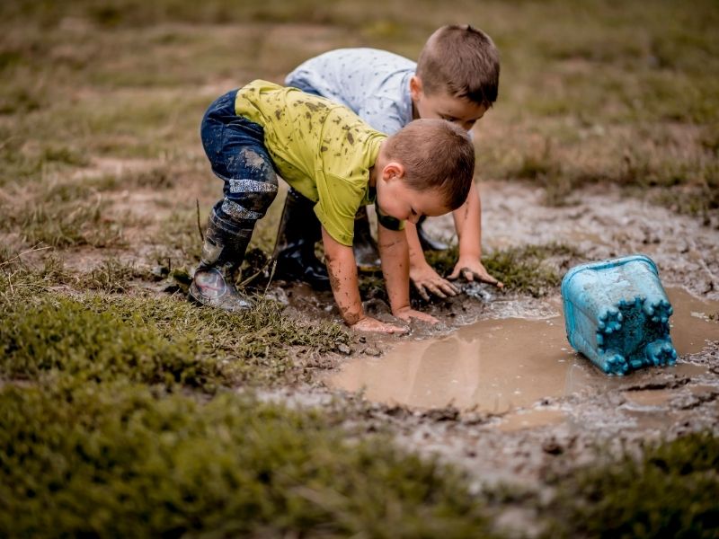 Preschoolers Playing In Mud