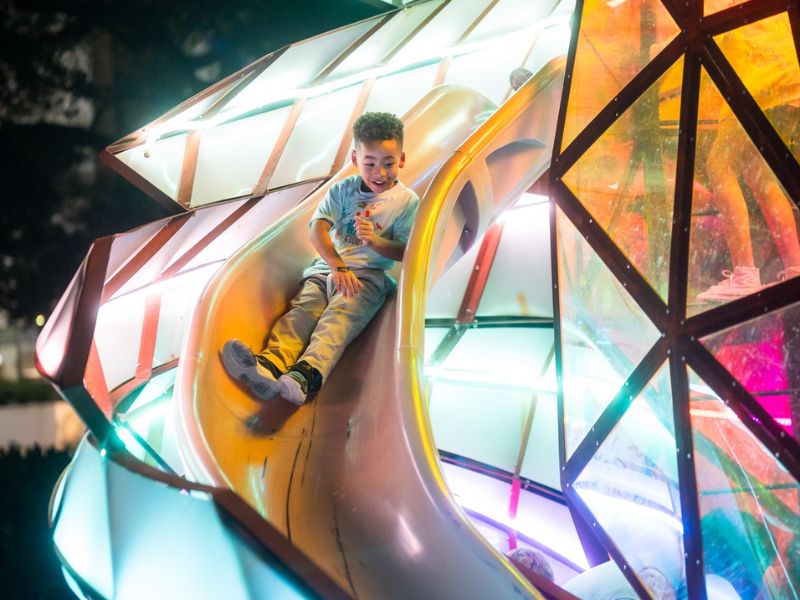 Return to the River 2025 boy on slide Grand Rapids Downtown Inc FB