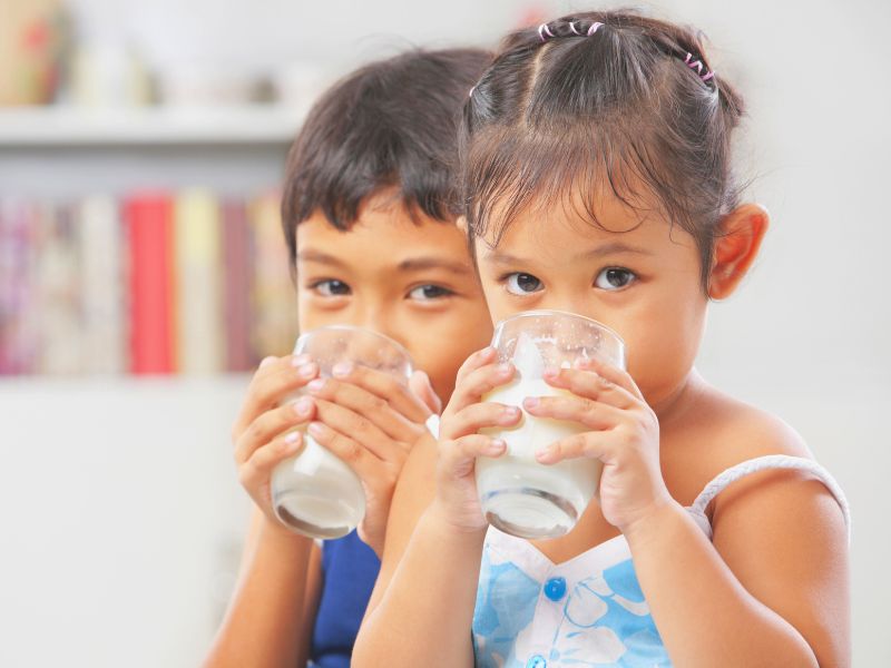 Boy and girl drinking milk