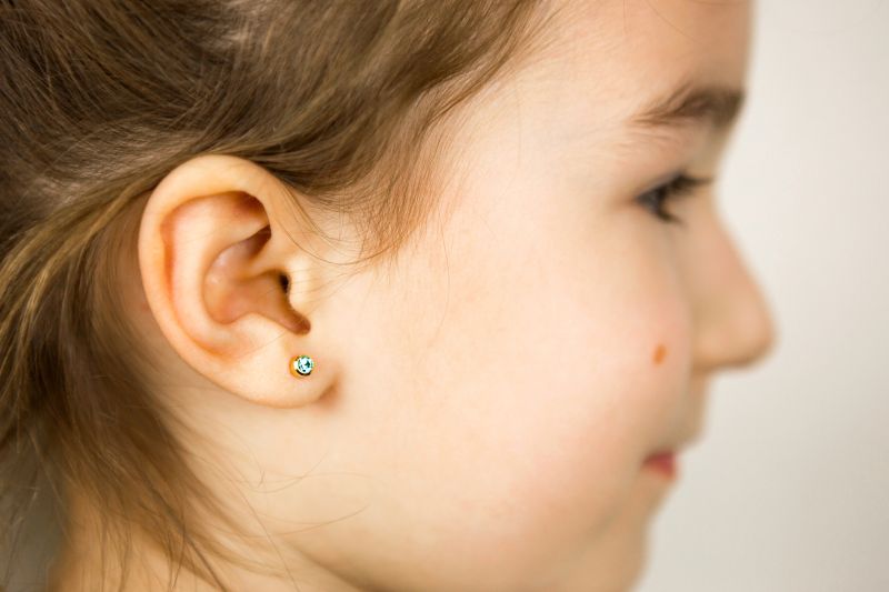 Kids Ear Piercing Places Earring In Young Girl