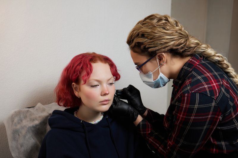 teen getting ears pierced 
